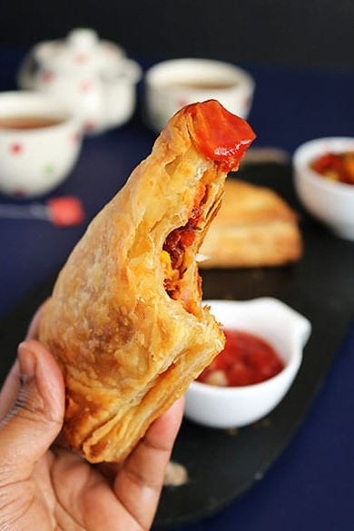 Stack of golden baked Maruti Live Puff pastries ready to serve