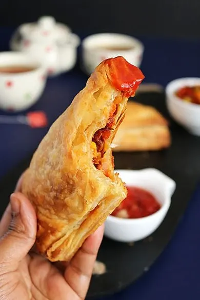 Stack of golden baked Maruti Live Puff pastries ready to serve