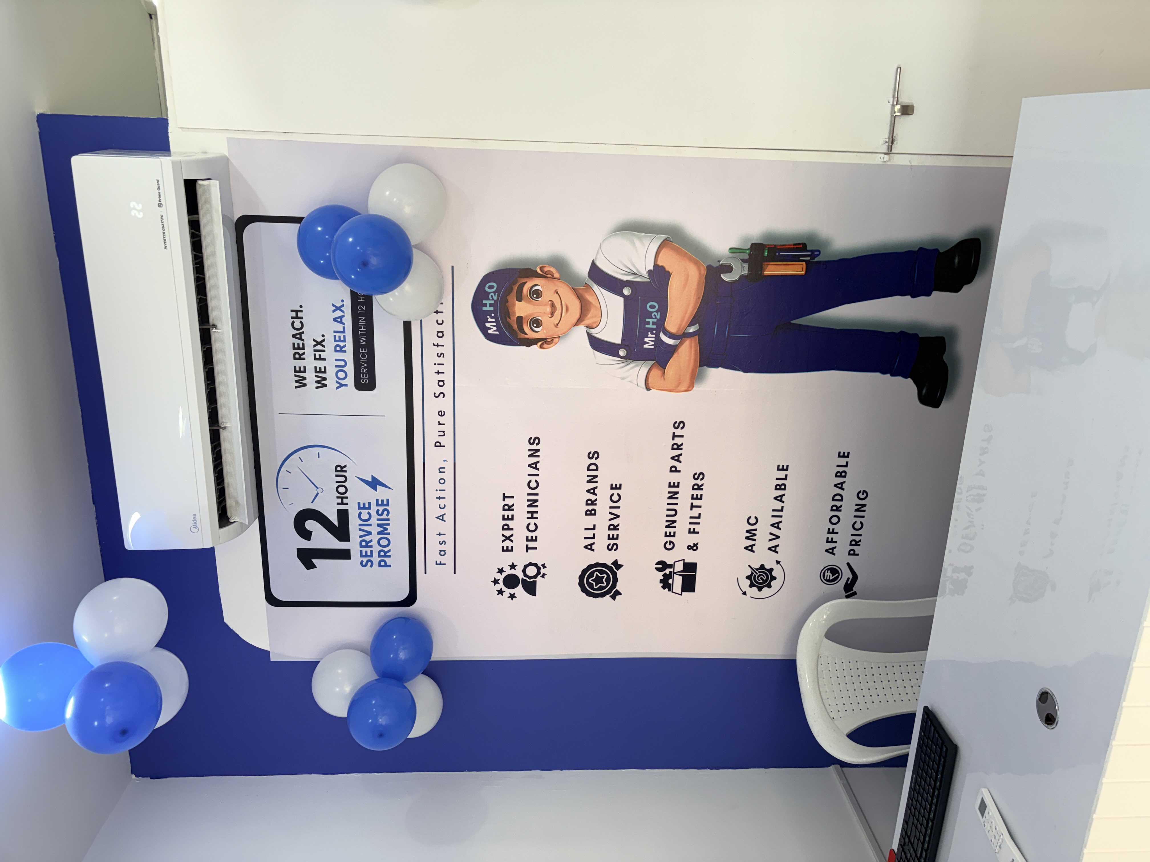 Mr. H2O in-store branding wall showing the 12 hour service promise and Fast Action Pure Satisfaction tagline with brand mascot