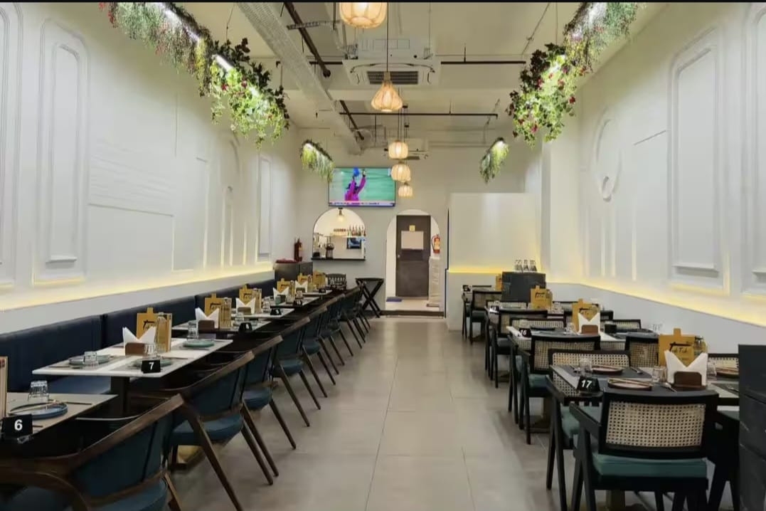 Thai Asian Food Restaurant, Ahmedabad — dining hall view toward the entrance and bar